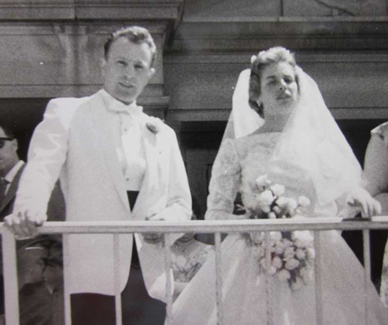 A bride and groom overlook a balcony on their wedding day.