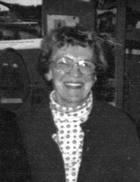 Mary as an older woman, wearing glasses.