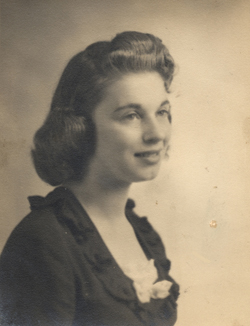 Portrait of a woman's profile, wearing dress with frilly collar and white bow.