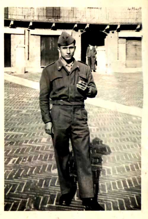 A young man in military uniform poses for a portrait.
