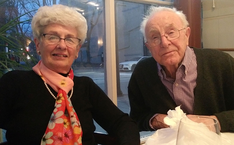 An older man and woman smile at the camera.