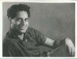 Portrait of young Om with hand draped over knee.