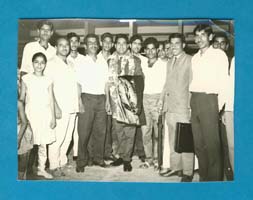 Group photo showing several people standing in a half circle.