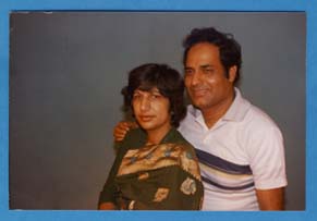 Om with hand on shoulder of his wife.