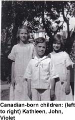 Three children standing in front of tree.