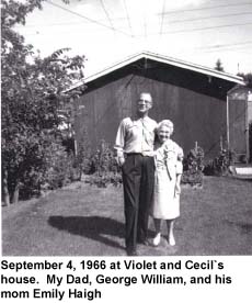 Man and woman standing on lawn on front of building.