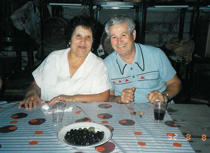 Beautiful couple sitting for photo.