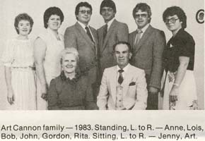 Family photo with mother and father seated and six children standing behind them.