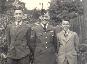 Arthur in uniform, with young son in suit on either side.