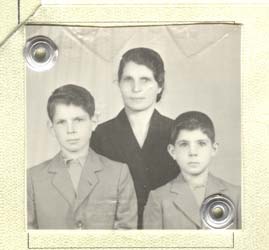 Family photograph for passport, woman in black a boy on each side.