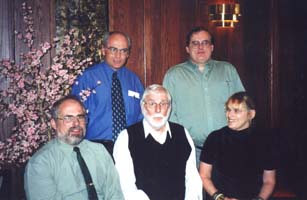 Older Robert, sitting in the middle of his four adult children.