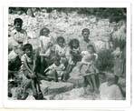 Old black and white family photograph taken outside.