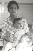Woman seated, with a baby in her lap.