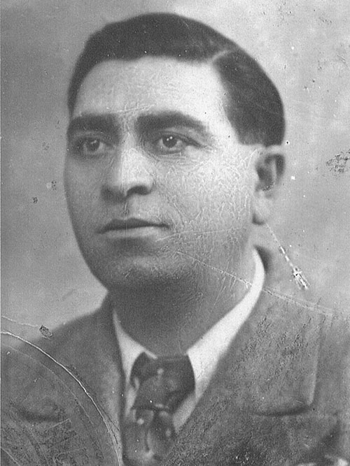 Pasquale head shot image, he is wearing a coat and tie.