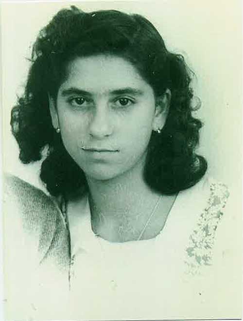 Portrait of young girl with shoulder length hair and small earrings.