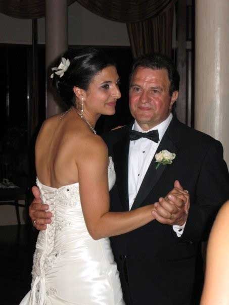 A bride and her father are dancing on her wedding night.
