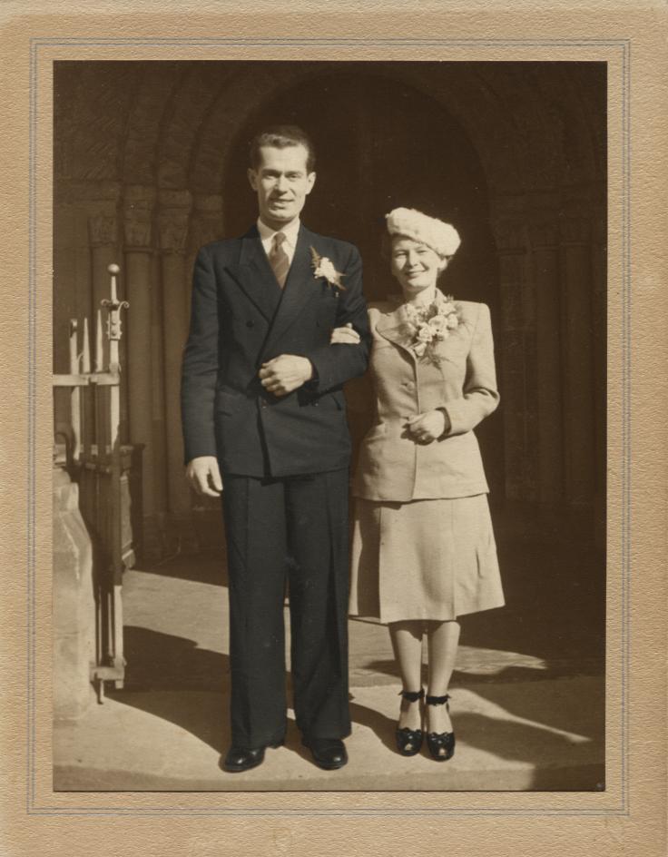 Bride and groom on church steps.