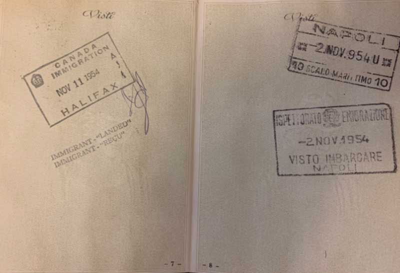 Old passport opened to pages with immigration stamps.