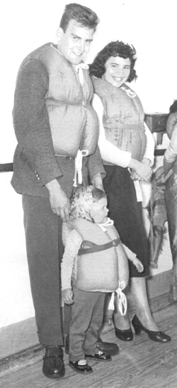 Man, woman and child wearing life vests.