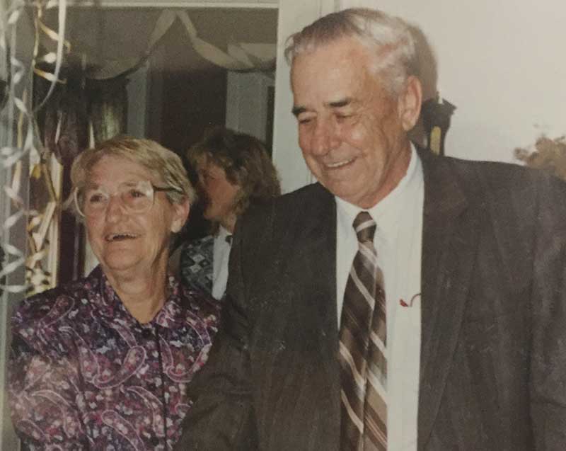 A young man and woman smile for the camera.