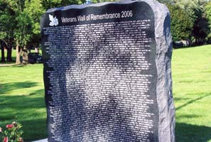 Stone with words Veteran's Wall of Remembrance 2006 and many names listed underneath.