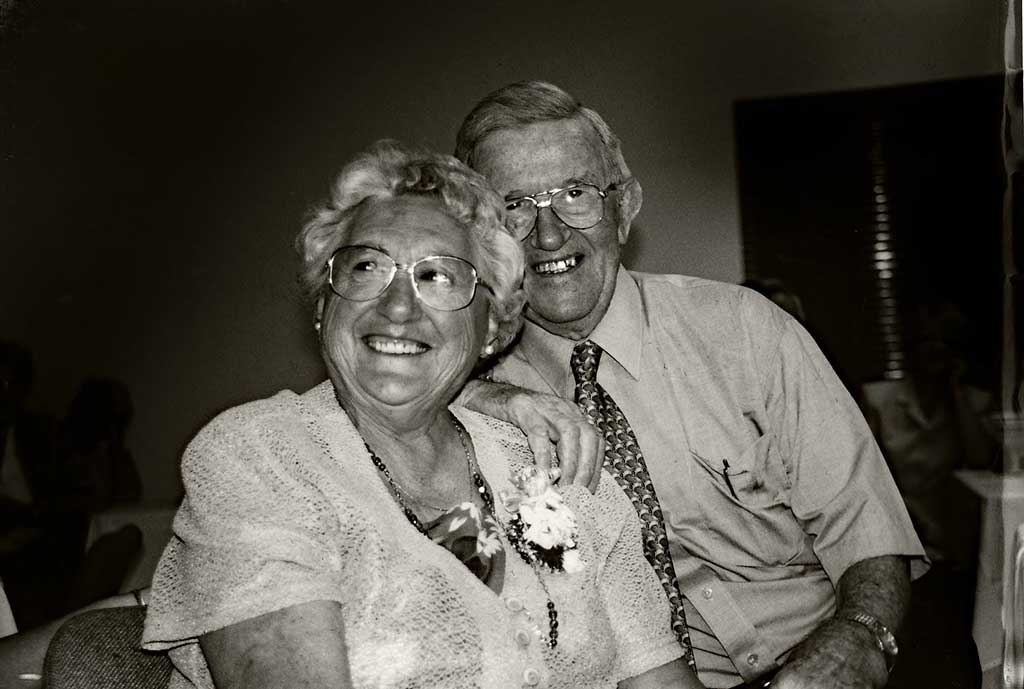 A very happy couple smile for the camera on their anniversary.