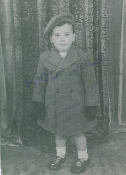 Baby boy Clifford in overcoat, gloves and tam.