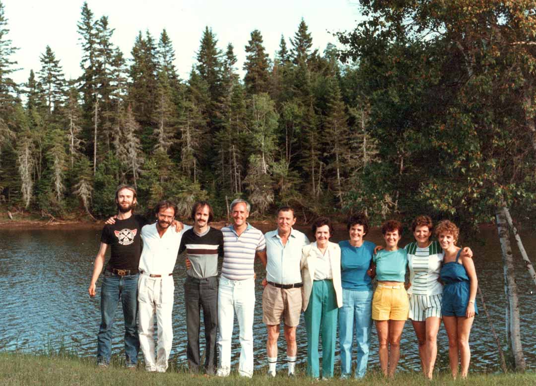 The entire Gallant family, 10 people, are lined up outside with the Shediac River behind them, Joan and Les are in the center.